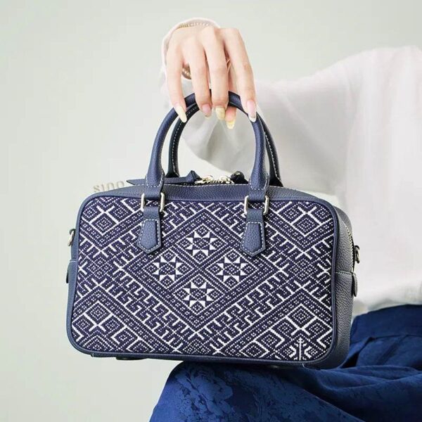 zhuang-brocade-flying-swallow-embroidered-leather-crossbody-bag-model-blue-dress-sitting-knee zhuang-brocade-flying-swallow-embroidered-leather-crossbody-bag-model-blue-dress-sitting-knee