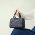 zhuang-brocade-flying-swallow-tote-bag-model-sitting-knee-blue-dress